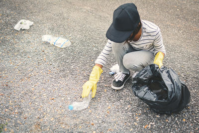 Volunteer collecting garbage on road