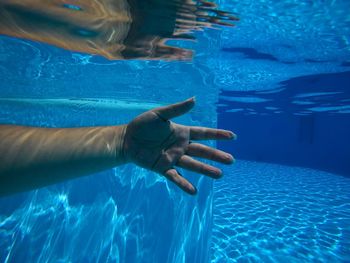 Low section of woman swimming in pool