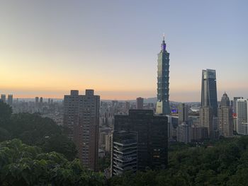 View of buildings in city during sunset