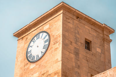 Low angle view of clock tower against sky