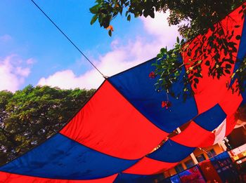 Low angle view of flags hanging against sky