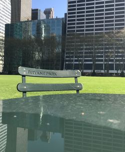 Metal railing by buildings in city