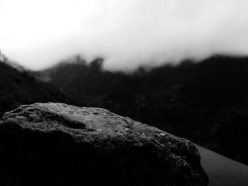 Close-up of rock against sky