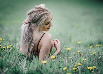 Young woman with flowers in field