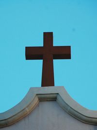 Low angle view of cross on church against clear sky