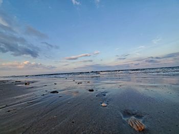 Scenic view of beach against sky during sunset