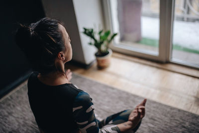 High angle view of girl sitting on floor at home