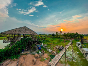 Panoramic view of houses and trees on field against sky