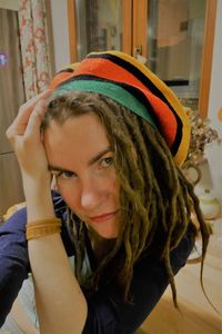 Close-up of woman with dreadlocks at home