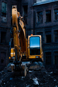 Abandoned construction site by buildings in city