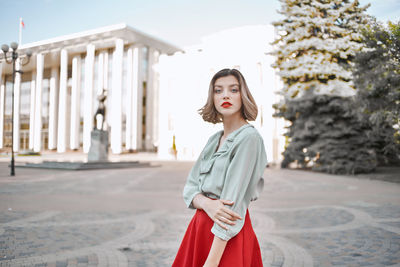 Portrait of beautiful young woman standing outdoors