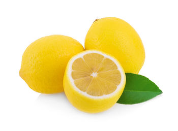 Close-up of orange fruit against white background