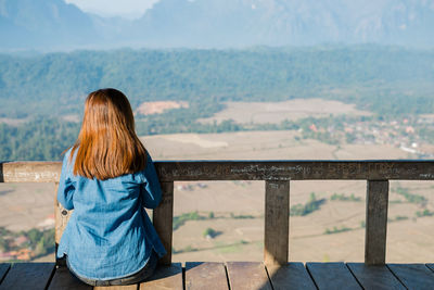 Rear view of woman looking at mountains