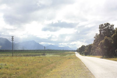 Empty road along countryside landscape