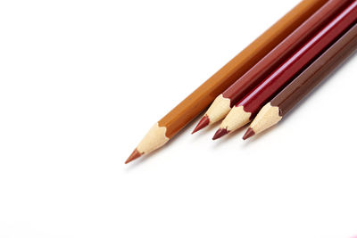 High angle view of colored pencils on white background