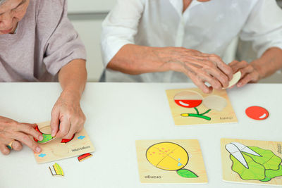 Midsection of business colleagues working on table