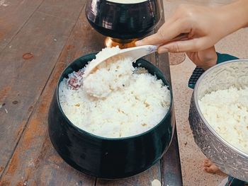 Midsection of person having food on table