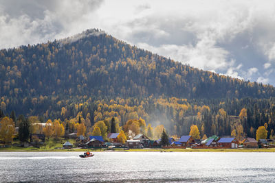 Scenic view of lake by mountain against sky