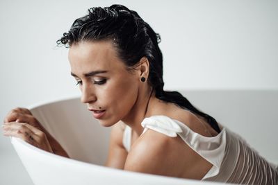 Close-up of woman sitting in bathtub