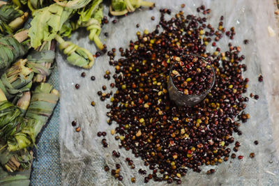 High angle view of legumes and glass on plastic