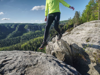 Sport athlete runner man in mountain trail. fitness man runner running on sunrise mountain top edge