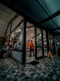 People walking in corridor of building