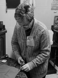 Female tailor cutting dress at table