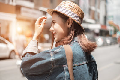 Midsection of woman wearing hat