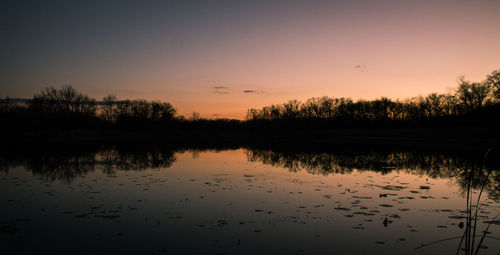 Scenic view of lake at sunset