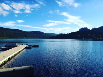 Scenic view of lake against cloudy sky