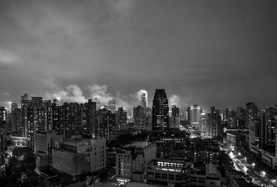 Illuminated cityscape against sky