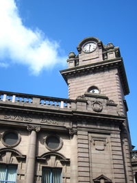 Low angle view of clock tower against sky