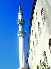 Low angle view of tower against blue sky