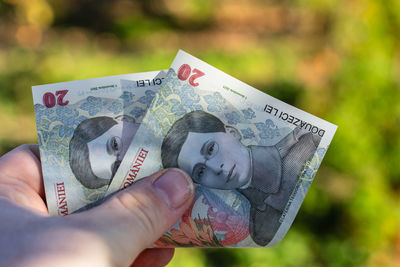 Close-up of hand holding paper currency