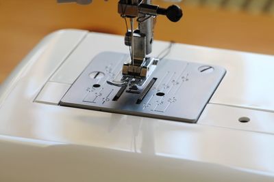 Close-up of sewing machine on table