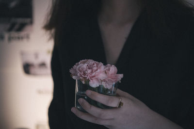 Close-up of hand holding flowering plant