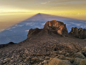 Scenic view of mountains against sky at sunset