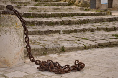 Close-up of chain against wall