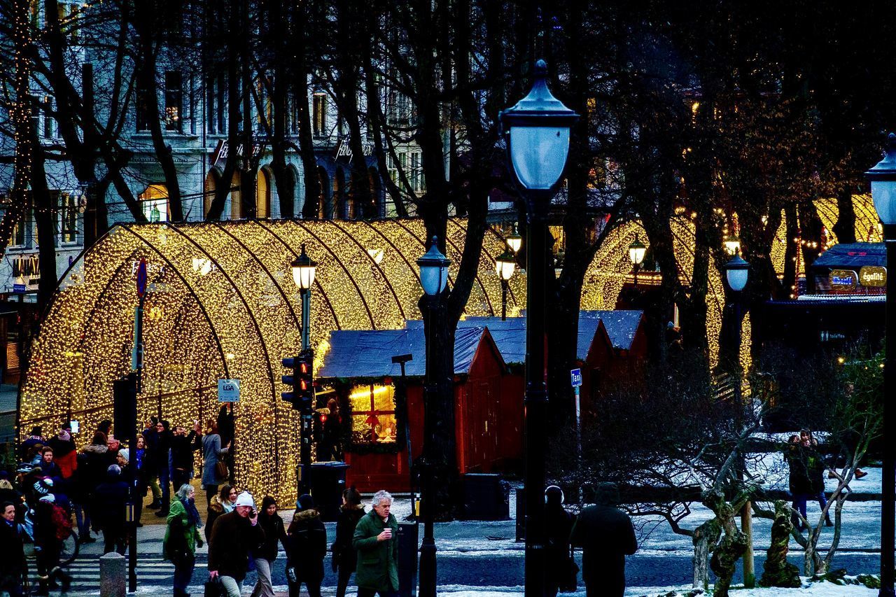 GROUP OF PEOPLE IN FRONT OF BUILDINGS