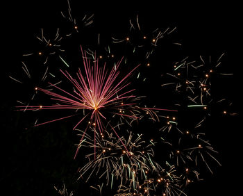 Low angle view of firework display at night