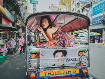 Portrait of woman standing on street in city