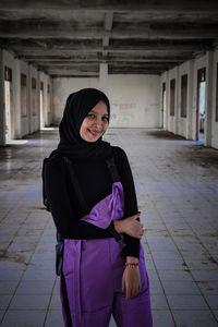 Woman standing in corridor of building