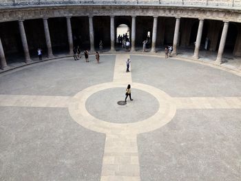 People walking in courtyard of historical building