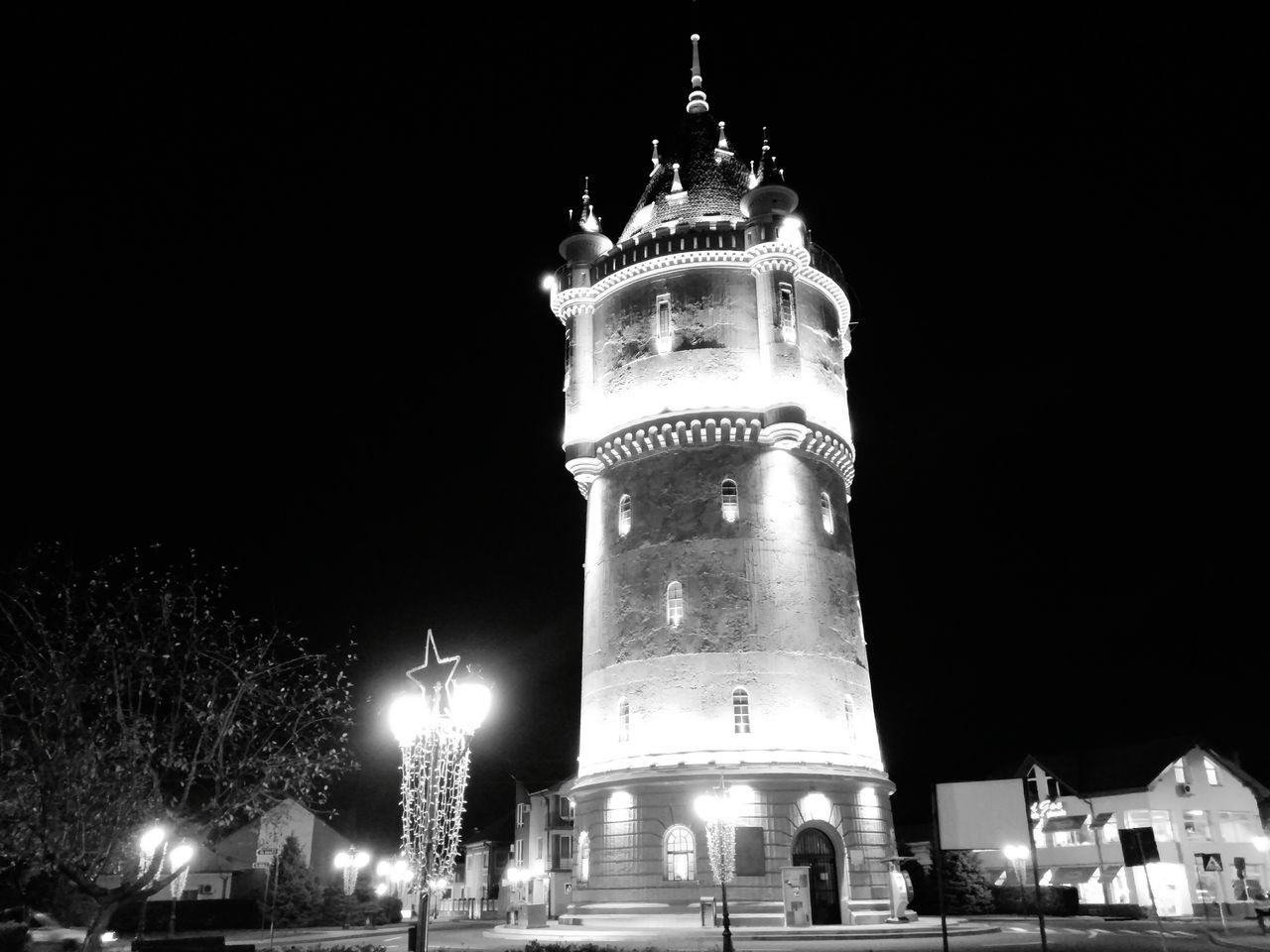 night, illuminated, architecture, building exterior, built structure, low angle view, sky, tower, street light, religion, lighting equipment, clock tower, outdoors, city, clear sky, travel destinations, history, light - natural phenomenon, no people