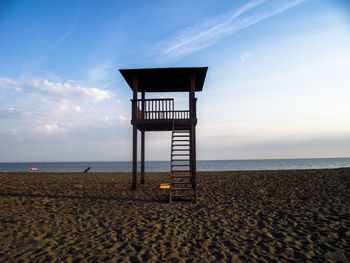 Lifeguard hut on beach against sky
