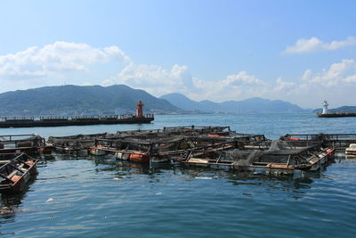 Fish farm at sea against cloudy sky