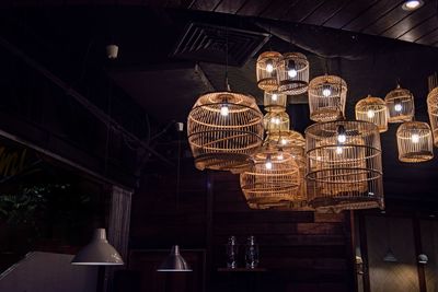 Low angle view of illuminated pendant lights hanging at restaurant