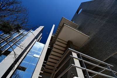 Low angle view of modern building against clear blue sky