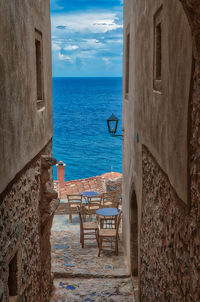 Scenic view of sea by building against sky