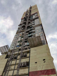 Low angle view of building against cloudy sky